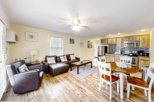 a living room with a couch and a table at Water-view condo at Sheepscot Harbour Resort with deck, full kitchen, and WiFi in Edgecomb
