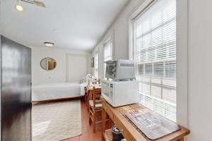 a room with a bed and a television on a table at Downtown, ground floor studio near the ocean w/patio, outdoor dining area & more in Wiscasset