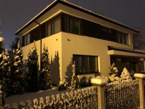 a house with a fence in the snow at Lux Villa Waldenburg in Wałbrzych