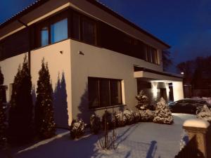 a house in the snow at night at Lux Villa Waldenburg in Wałbrzych