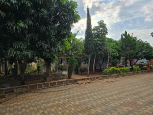 a park with trees and a brick road at Rose Petals in Sagana +3 photos