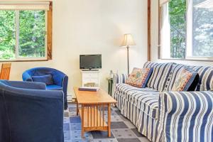 a living room with a couch and two chairs and a table at Woodland Home near Long Pond w/ Spacious Living Area, Full Kitchen & Deck in Somesville