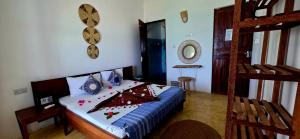 a bedroom with a bed in a room with a ladder at Equalia boutique hotel in Jambiani +29 photos
