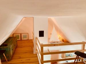 a room with a staircase with a sailboat on the wall at Landhaus Börmoos in Steinberg