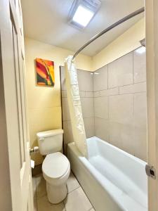 a bathroom with a toilet and a bath tub at Texas Inn Beaumont in Beaumont