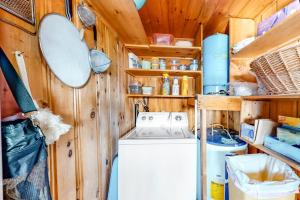 a laundry room with a washing machine and wooden walls at Vintage lakefront cabin with incredible water views, private dock & pebble beach in The Highlands +19 photos