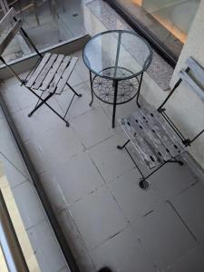 a table and two chairs and a glass table and chairs at Bran' s in Constanţa