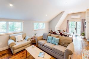 a living room with a couch and a table at Cozy and modern hideaway - walk to the beach - fast WiFi & washer/dryer in Marlboro