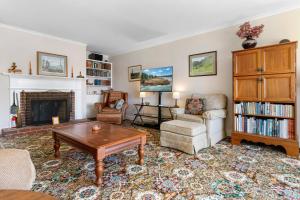 a living room filled with furniture and a fireplace at Dog-friendly oceanfront home with private shorefront, two fireplaces, & firepit in Steuben