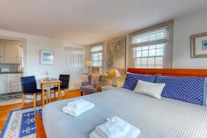 a bedroom with a bed with two towels on it at Lovely studio w/full kitchen/free WiFi- next to river/antique shops/restaurants in Wiscasset