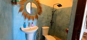 a bathroom with a sink and a mirror at Equalia boutique hotel in Jambiani