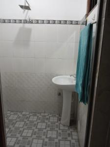 a bathroom with a white sink and a blue towel at The Emerald Ceylon - Colombo in Pannipitiya