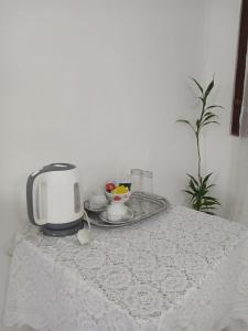 a table with a toaster and a bowl of fruit at The Emerald Ceylon - Colombo in Pannipitiya