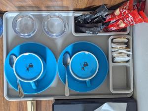 a lunch box with blue plates and spoons at Luma Boutique Hotel Omadhoo in Omadhoo