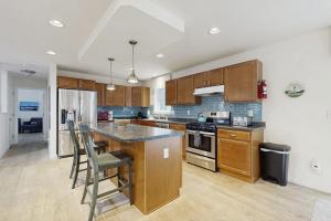 a kitchen with wooden cabinets and a counter top at Secluded Dog-Friendly Getaway w/ Free WiFi, Private Washer/Dryer, Furnished Deck in Southport +19 photos
