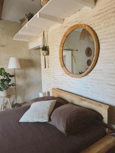 a bedroom with a large mirror above a bed at Escapade bohème in Bergerac +14 photos