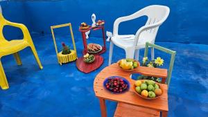 a toy room with a table with bowls of fruit on it at Super sea promenade apartment in El Mîna