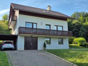 a house with a car parked in front of it at Elly Apartment - 20 min to Ljubljana in Kresnice