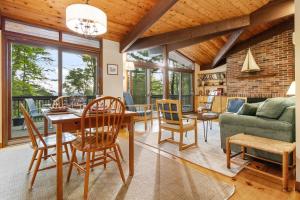a living room with a table and chairs at Beautiful hidden Waterfront Retreat with Rocky Beach in Boothbay