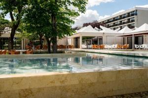 a swimming pool in front of a building at Resort Cupidon Neptun in Neptun