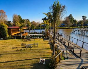 a person standing on the grass next to a body of water at Kanoo Lodge in Tigre