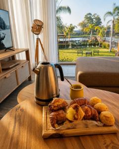 a plate of food on a table with a tea kettle at Kanoo Lodge in Tigre