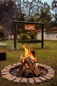 a fire pit in the middle of a yard at Private Suite with Kitchen & Pool Access in Itapetininga