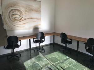 a conference room with chairs and a wooden table at Private Suite with Kitchen & Pool Access in Itapetininga +26 photos