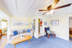 a living room with a couch and a ceiling fan at Dog-friendly Fisher Hill home with patio and wood stove - walk to the harbor in Boothbay Harbor