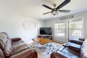 a living room with a couch and a table at Dog-friendly home with deck, pool table, & firepit - walk to downtown Boothbay in Boothbay Harbor