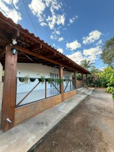 a house with a wooden building with a fence at Casa Pé da Serra in Estivado
