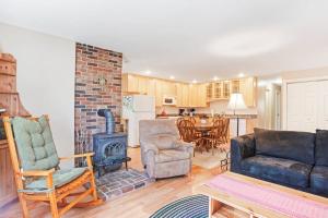 a living room with a couch and a stove at Dog-friendly home in great locale close to the ocean with yard, streaming, W/D in Tremont
