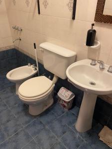 a bathroom with a toilet and a sink at Siempre verde3 in Merlo