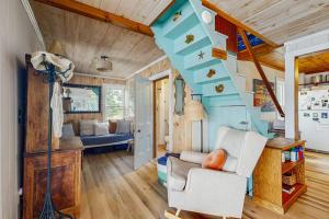 a living room with a staircase in a house at Charming Oceanfront Home with Stunning Water Views and Wifi in Georgetown