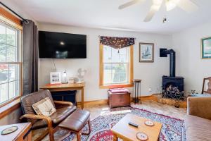 a living room with a couch and a fireplace at Two-story home steps from Laite Beach - stroll to the harbor, 1 dog welcome in Camden