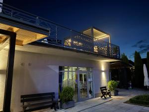 a building with a balcony on top of it at Willa Galeon in Sarbinowo