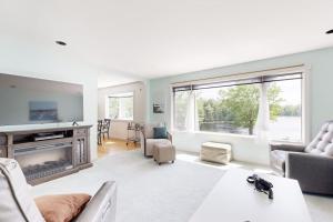 a living room with a couch and a fireplace at Charming Lakefront House with Outdoor Firepit, Washer/Dryer and Wifi in Gouldsboro