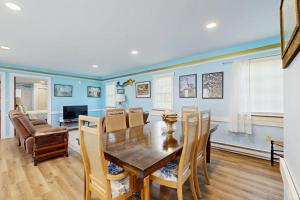 a dining room with a wooden table and chairs at Charming, single-level getaway with a full kitchen, fast WiFi, & grassy yard in Boothbay