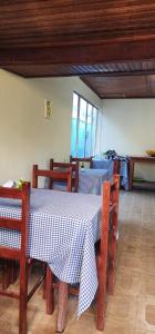a dining room with a table and chairs with a blue and white tablecloth at Aconchego Mineiro in Visconde De Maua