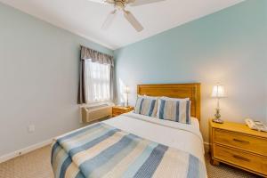 a bedroom with a bed and a ceiling fan at Efficient Getaway with Free WiFi - Close to Acadia National Park in Northeast Harbor