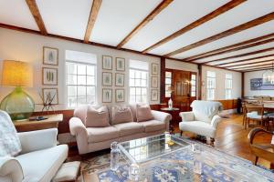 a living room with a couch and a table at All-suite Boothbay Harbor home with deck, ocean views, and fireplaces in Boothbay Harbor