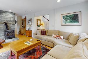 a living room with a couch and a fireplace at Gorgeous, walkable home with water view, deck & washer/dryer - snowbird-friendly in Camden