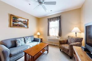 a living room with a couch and a tv at Lovely downtown Northeast Harbor suite near the water and near Acadia in Northeast Harbor
