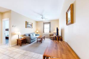 a living room with a table and a couch at Lovely downtown Northeast Harbor suite near the water and near Acadia in Northeast Harbor +8 photos