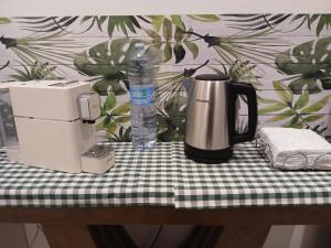 a coffee maker and a bottle of water on a table at Affittacamere DA MARIA TERESA in Sestri Levante
