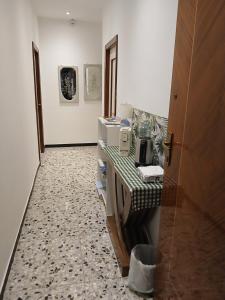 a room with a hallway with a table and a room with paintings at Affittacamere DA MARIA TERESA in Sestri Levante +14 photos