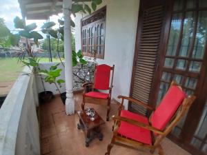 two chairs and a table on a porch at The Emerald Ceylon - Colombo in Pannipitiya