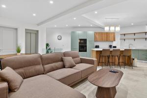 a living room with a couch and a table at Stylish Penthouse with private Pool andJacuzzi in Naxxar