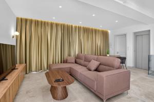 a living room with a couch and a table at Stylish Penthouse with private Pool andJacuzzi in Naxxar