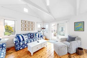 a living room with a couch and two chairs at Oceanfront Cottage & Studio on Mill Cove w/ Water Views, Deck - Walk Downtown in Boothbay Harbor